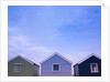 Beach huts in a row against sky by Assaf Frank